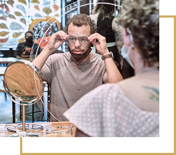 Man trying on glasses at Oscar Oglethorpe