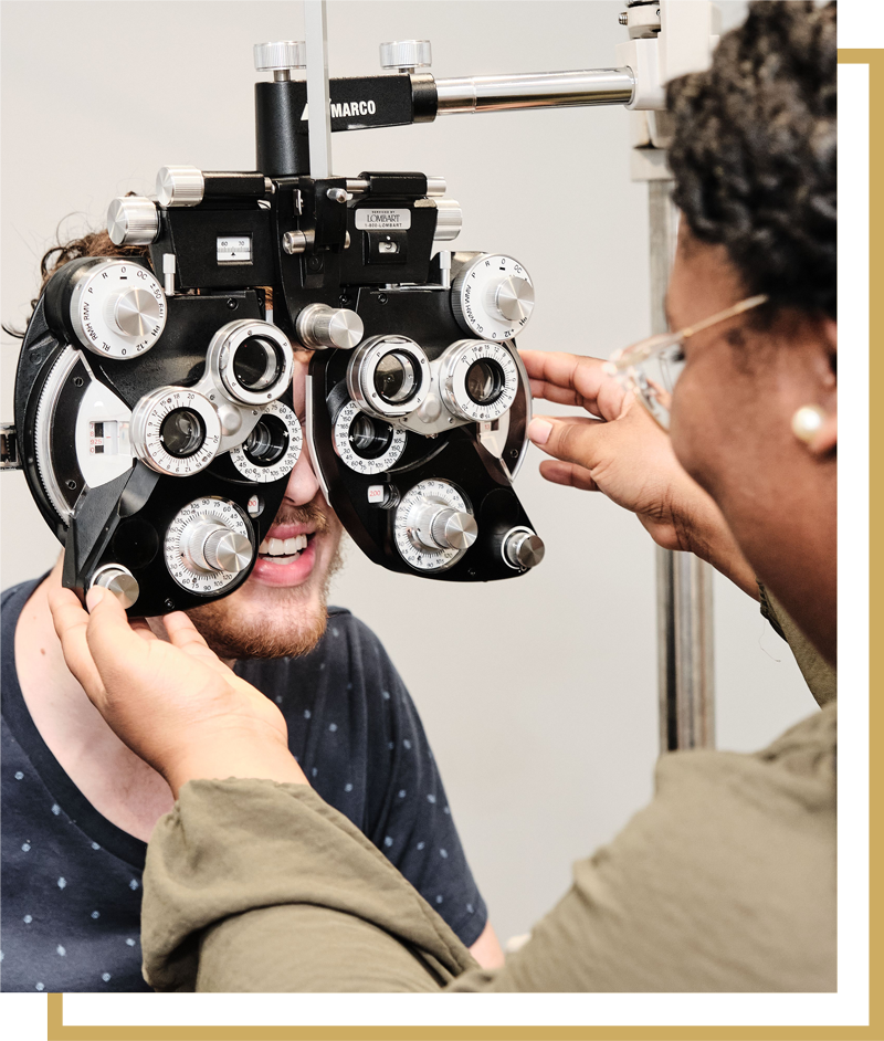Man trying on glasses at Oscar Oglethorpe